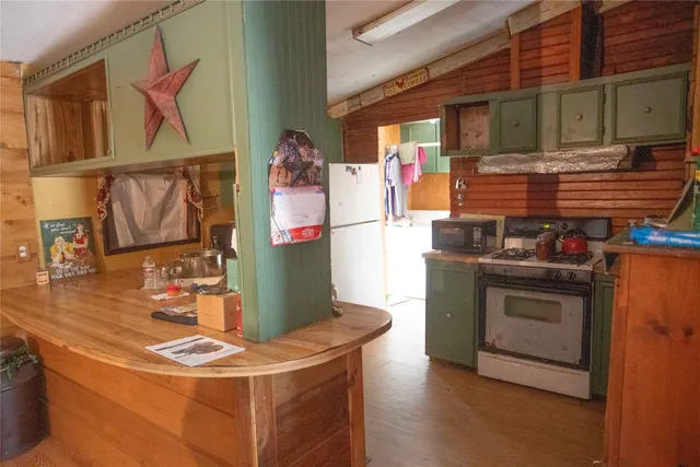 a kitchen with stainless steel appliances granite countertop a stove and a refrigerator