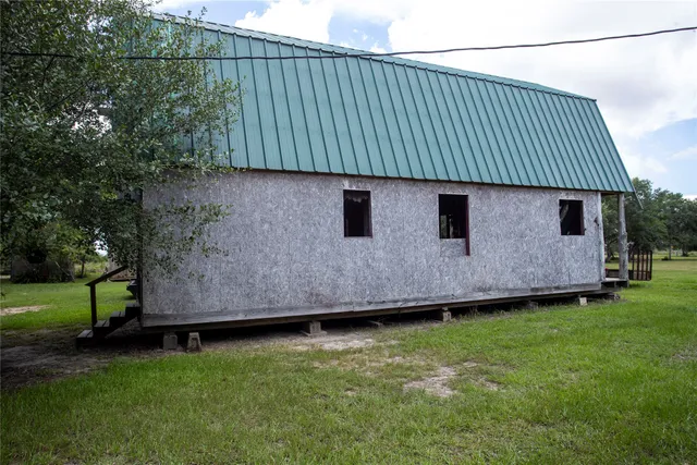 a backyard of a house with wooden floor and fence