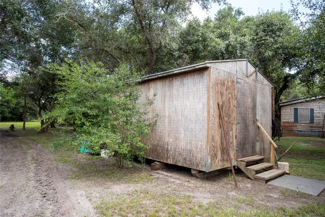 a backyard of a house with trampoline and entertaining space