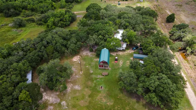 an aerial view of a house with a yard
