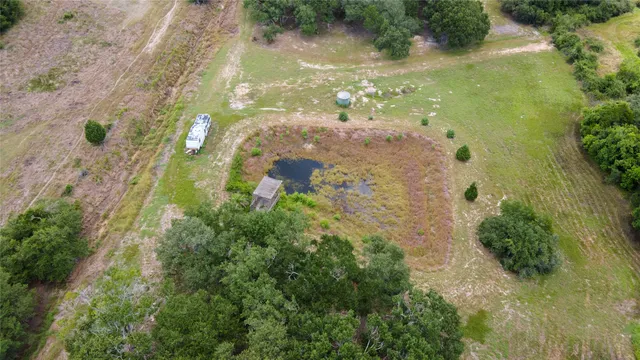 an aerial view of a residential houses with outdoor space