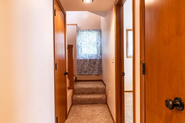 a view of a hallway with a door and couch