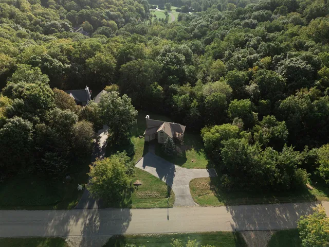 an aerial view of a house with a yard basket ball court and outdoor seating