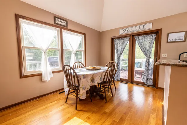 a view of a dining room with furniture and windows