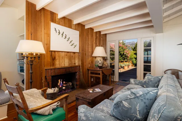 a living room with furniture wooden floor and a table
