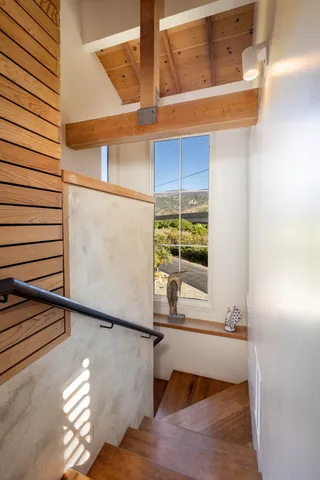 a view of a balcony with wooden floor and potted plants