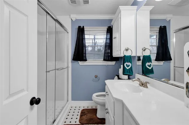 a bathroom with a sink a toilet and mirror