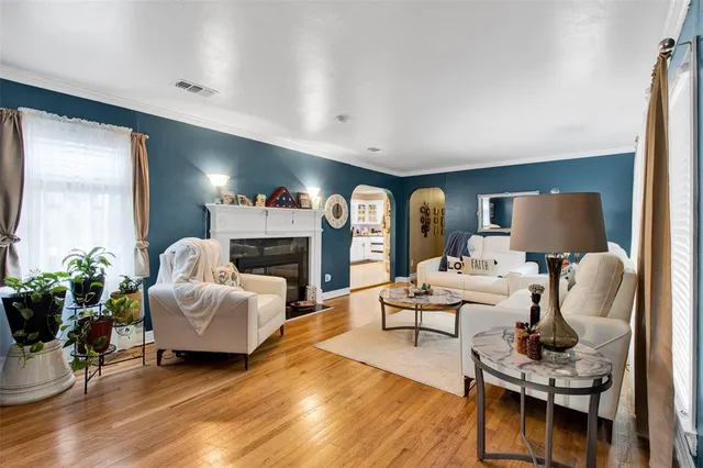 a living room with fireplace furniture and a wooden floor