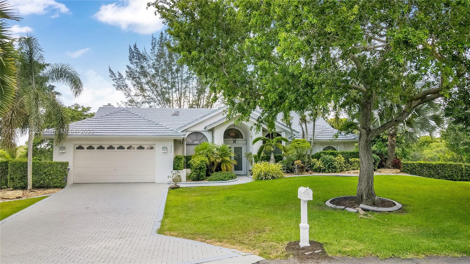 20310 Southwest 48th Street Southwest Ranches, FL 33332 - Photo 1 of 25 a front view of a house with garden