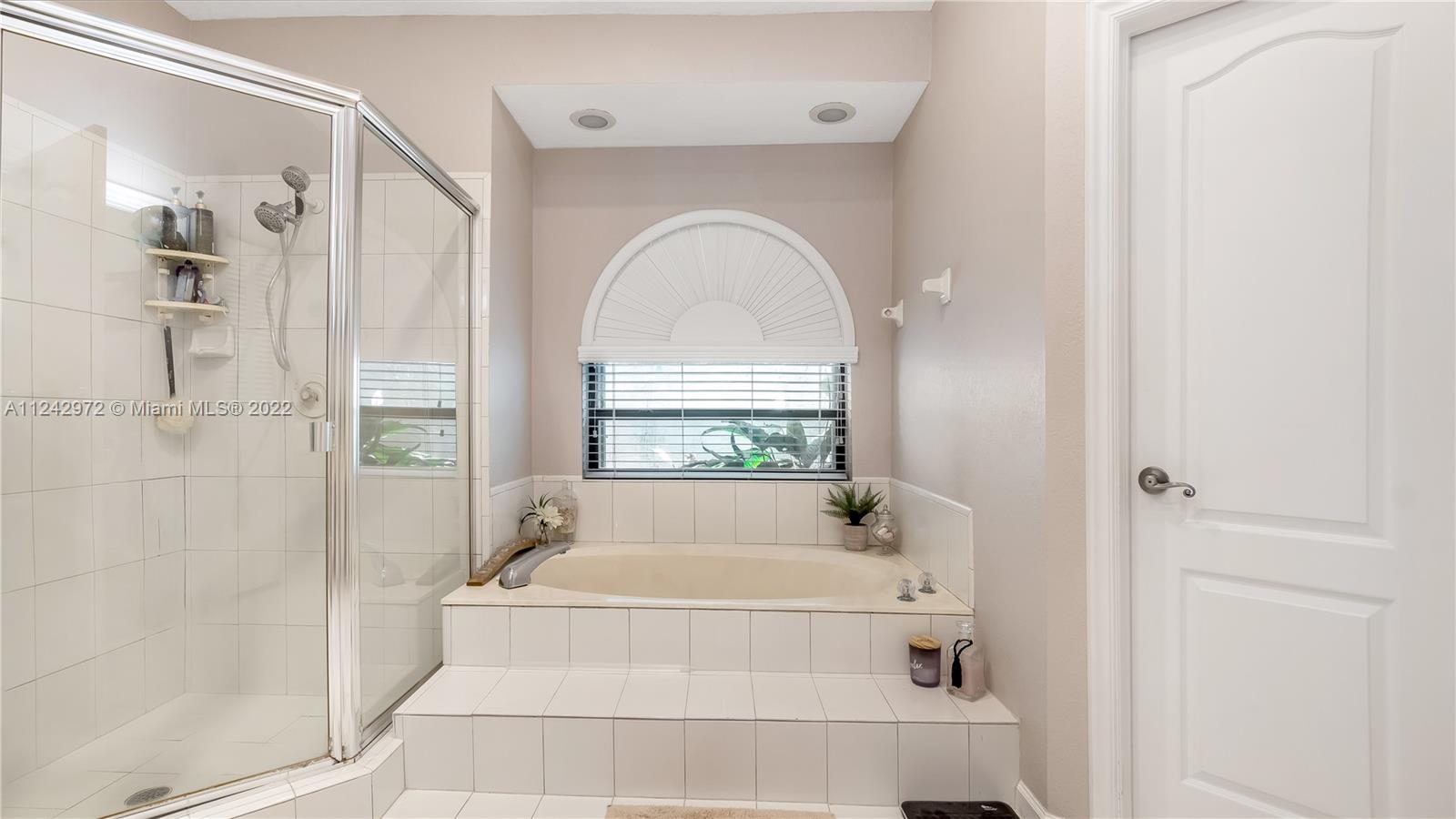 20310 Southwest 48th Street Southwest Ranches, FL 33332 - Photo 11 of 25 a bathroom with a tub and shower