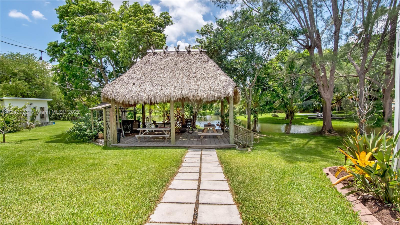 20310 Southwest 48th Street Southwest Ranches, FL 33332 - Photo 21 of 25 a view of a patio with a table and chairs under an umbrella