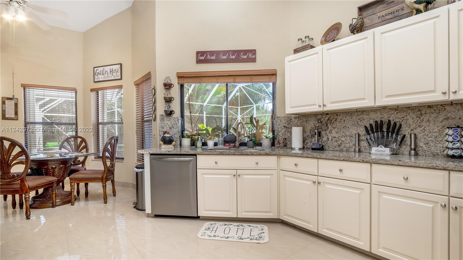 20310 Southwest 48th Street Southwest Ranches, FL 33332 - Photo 5 of 25 a kitchen with stainless steel appliances granite countertop a stove and white cabinets