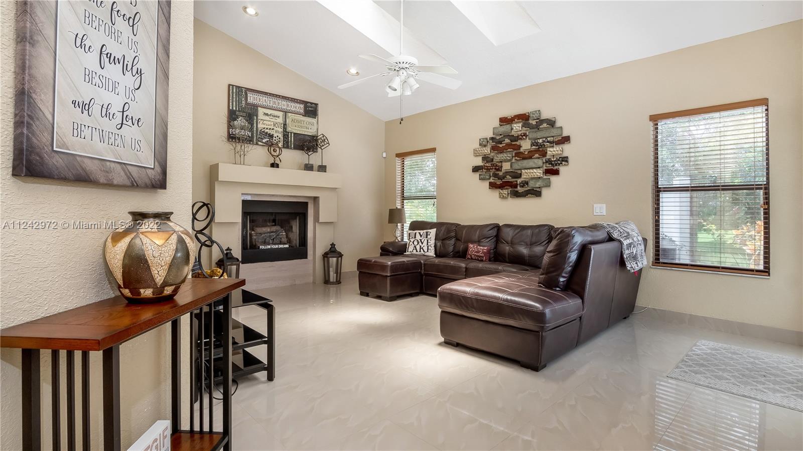 20310 Southwest 48th Street Southwest Ranches, FL 33332 - Photo 8 of 25 a living room with furniture and a fireplace