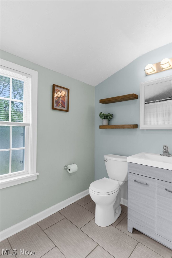 3625 Ludgate Road Cleveland, OH 44120 - Photo 8 of 16 Bathroom with vaulted ceiling, tile flooring, vanity, and toilet