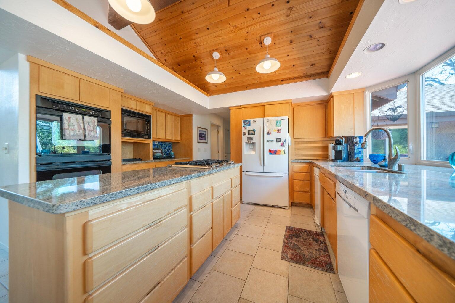 8846 Goldstone Lane Redding, CA 96001 - Photo 21 of 64 a kitchen with stainless steel appliances granite countertop sink and cabinets