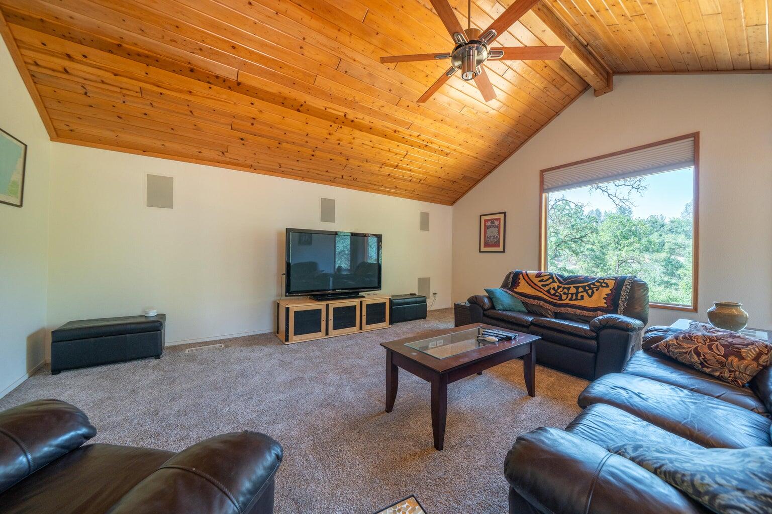 8846 Goldstone Lane Redding, CA 96001 - Photo 25 of 64 a living room with furniture a window and a flat screen tv