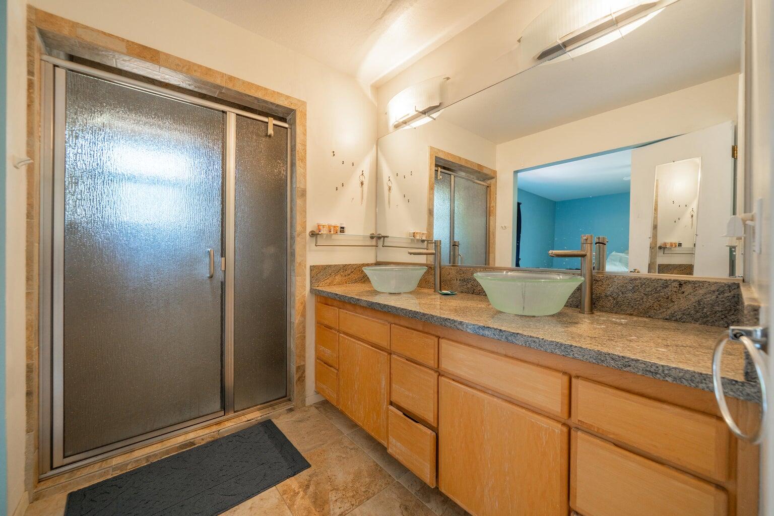 8846 Goldstone Lane Redding, CA 96001 - Photo 30 of 64 a bathroom with a granite countertop sink and a mirror