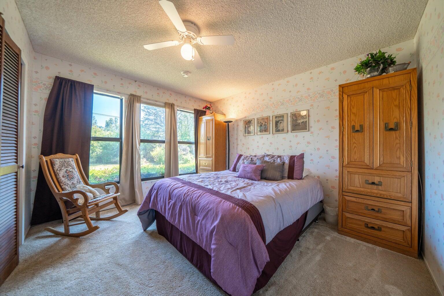 8846 Goldstone Lane Redding, CA 96001 - Photo 32 of 64 a bedroom with a bed a couch and dresser