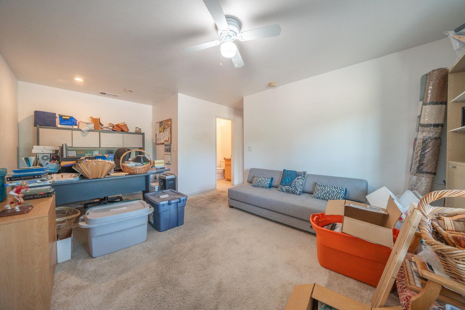 8846 Goldstone Lane Redding, CA 96001 - Photo 39 of 64 a living room with furniture a rug and a chandelier