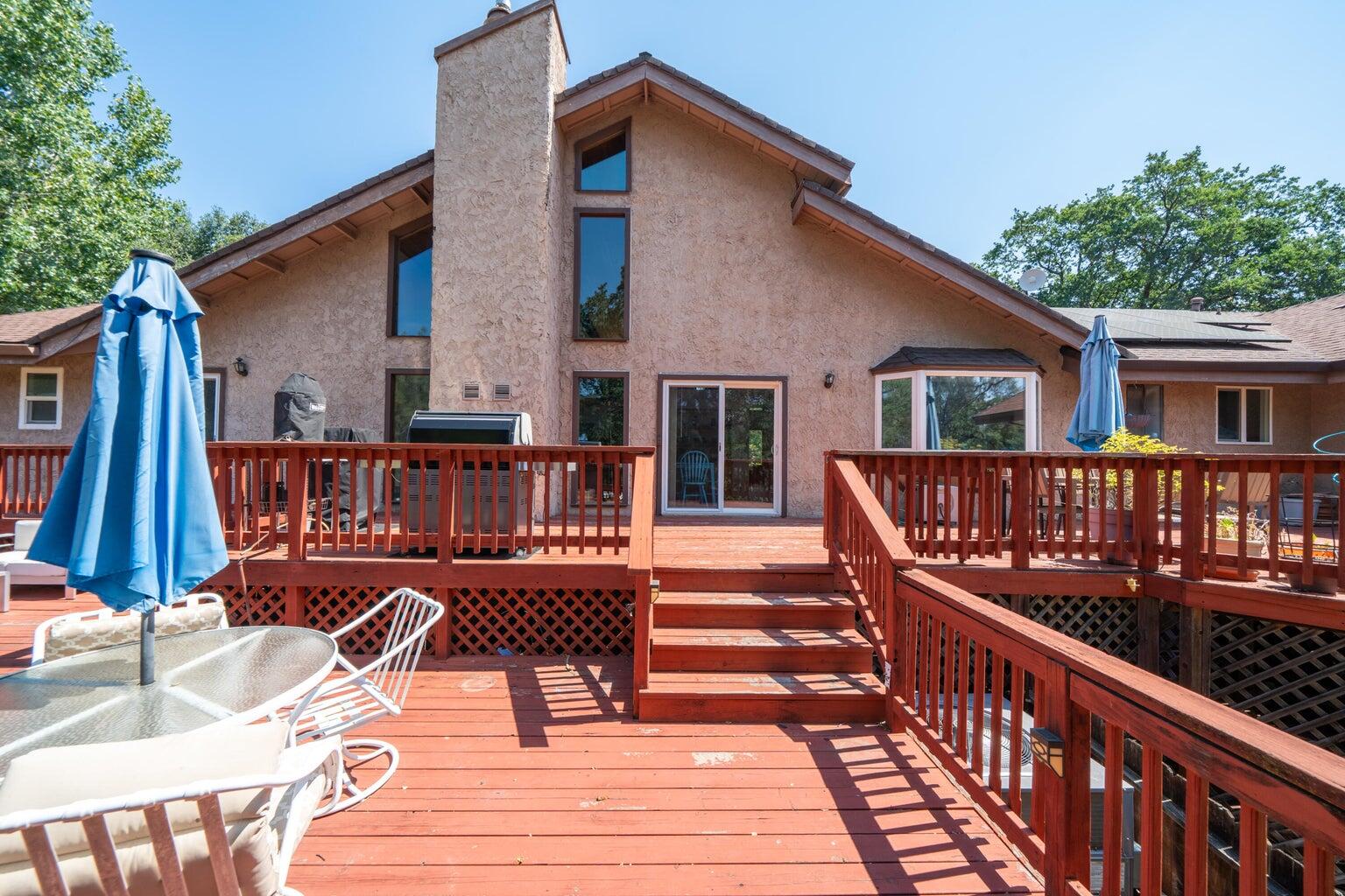 8846 Goldstone Lane Redding, CA 96001 - Photo 50 of 64 a view of a house with wooden deck and furniture