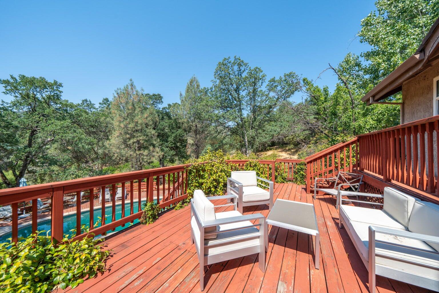 8846 Goldstone Lane Redding, CA 96001 - Photo 51 of 64 a view of a balcony with wooden floor and outdoor seating