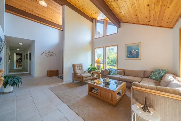 a living room with furniture a fireplace and a large window