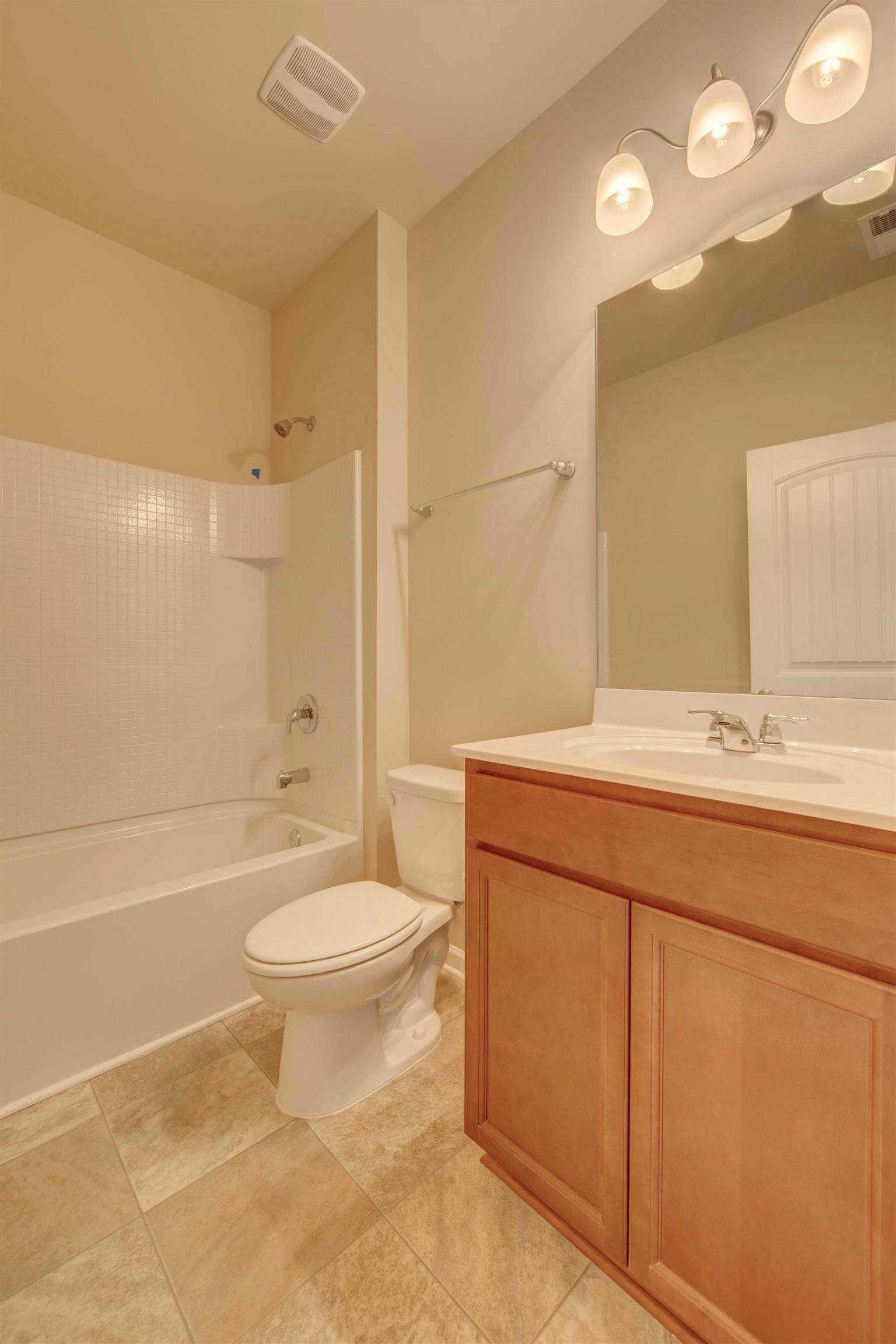 744 Prominence Road, Unit 66 Columbia, TN 38401 - Photo 5 of 17 a bathroom with a granite countertop toilet a sink and a bathtub