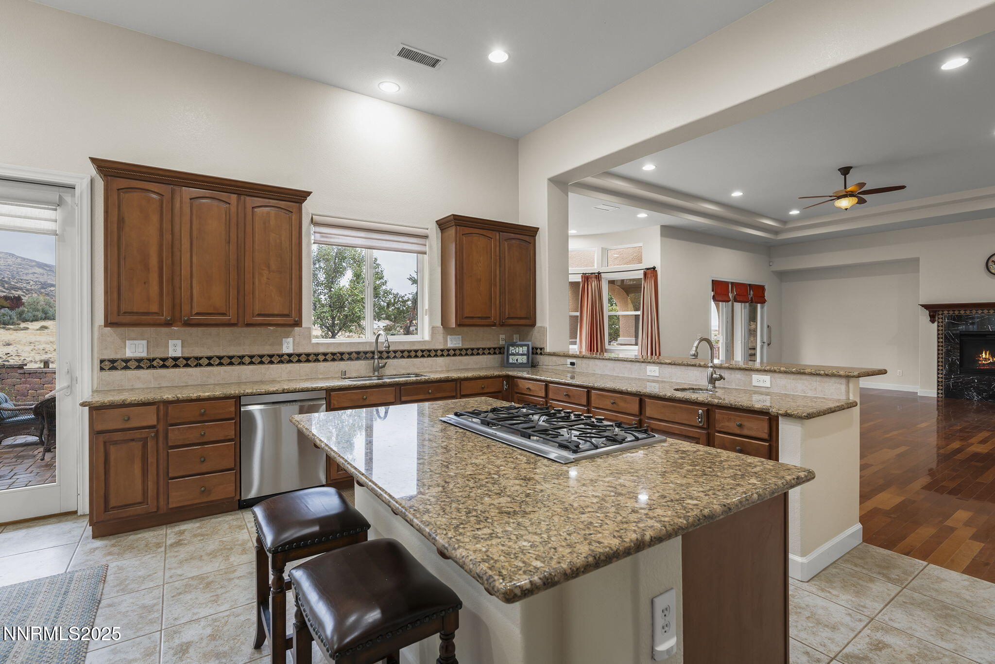 6225 Elk Ivory Drive Reno, NV 89511 - Photo 11 of 44 a kitchen with granite countertop kitchen island stainless steel appliances a sink stove and cabinets