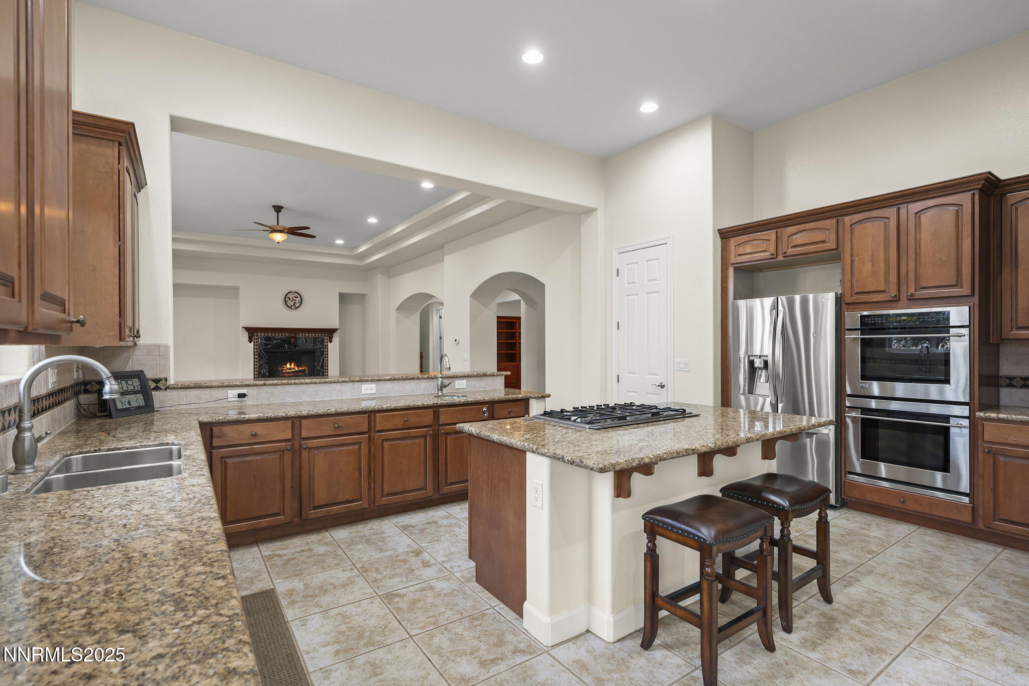 6225 Elk Ivory Drive Reno, NV 89511 - Photo 12 of 44 a kitchen with stainless steel appliances granite countertop a stove a sink and a refrigerator