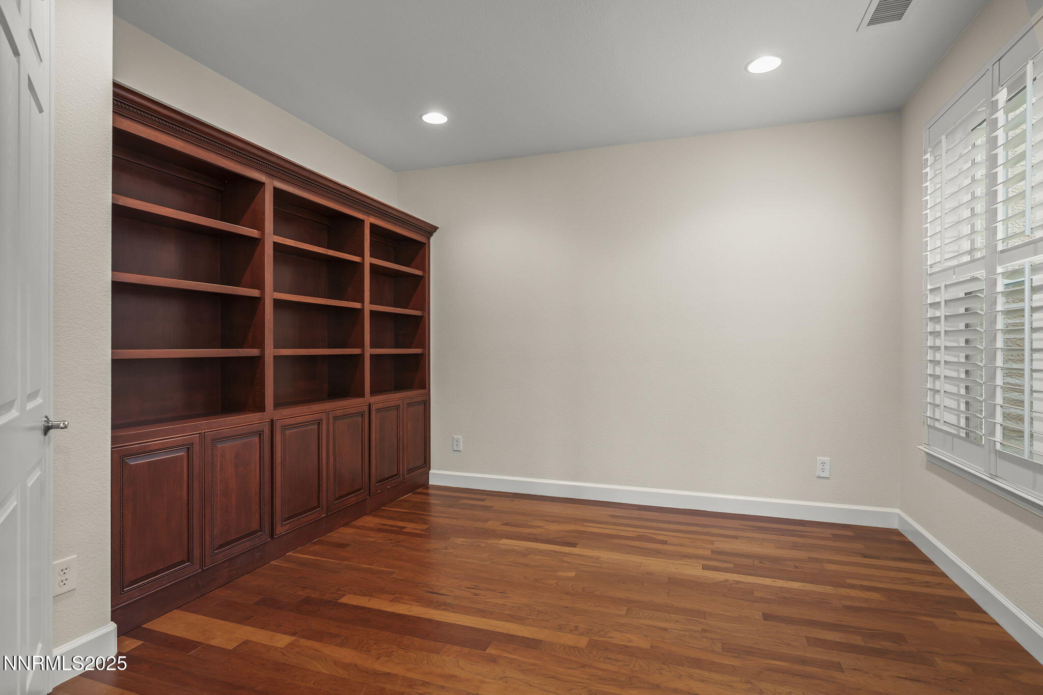 6225 Elk Ivory Drive Reno, NV 89511 - Photo 15 of 44 a view of an empty room with a window and wooden floor