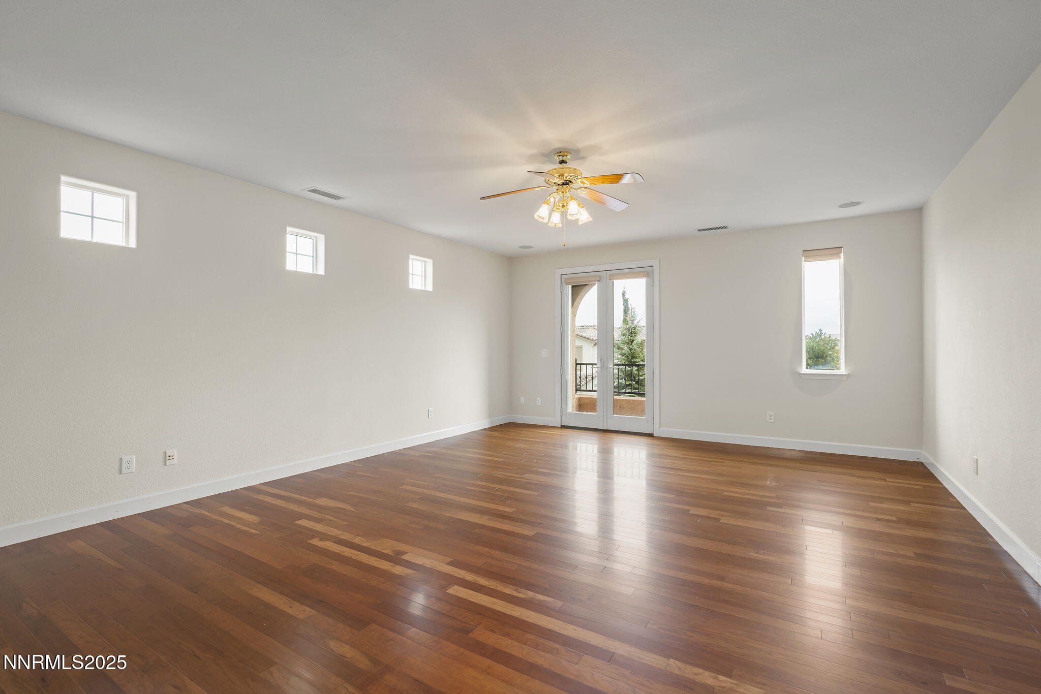 6225 Elk Ivory Drive Reno, NV 89511 - Photo 19 of 44 a view of an empty room with window and wooden floor