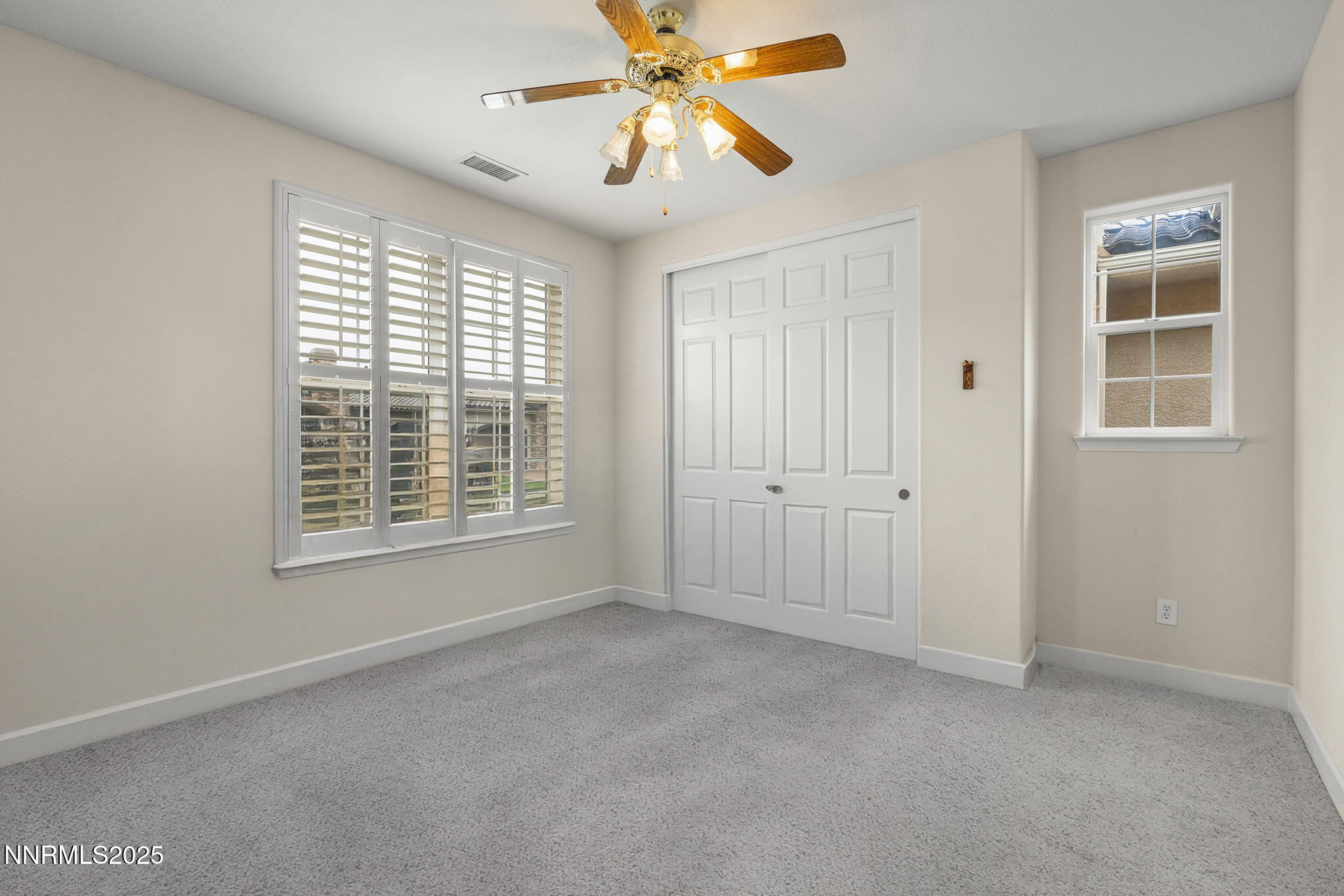 6225 Elk Ivory Drive Reno, NV 89511 - Photo 21 of 44 a view of an empty room with a window and a kitchen