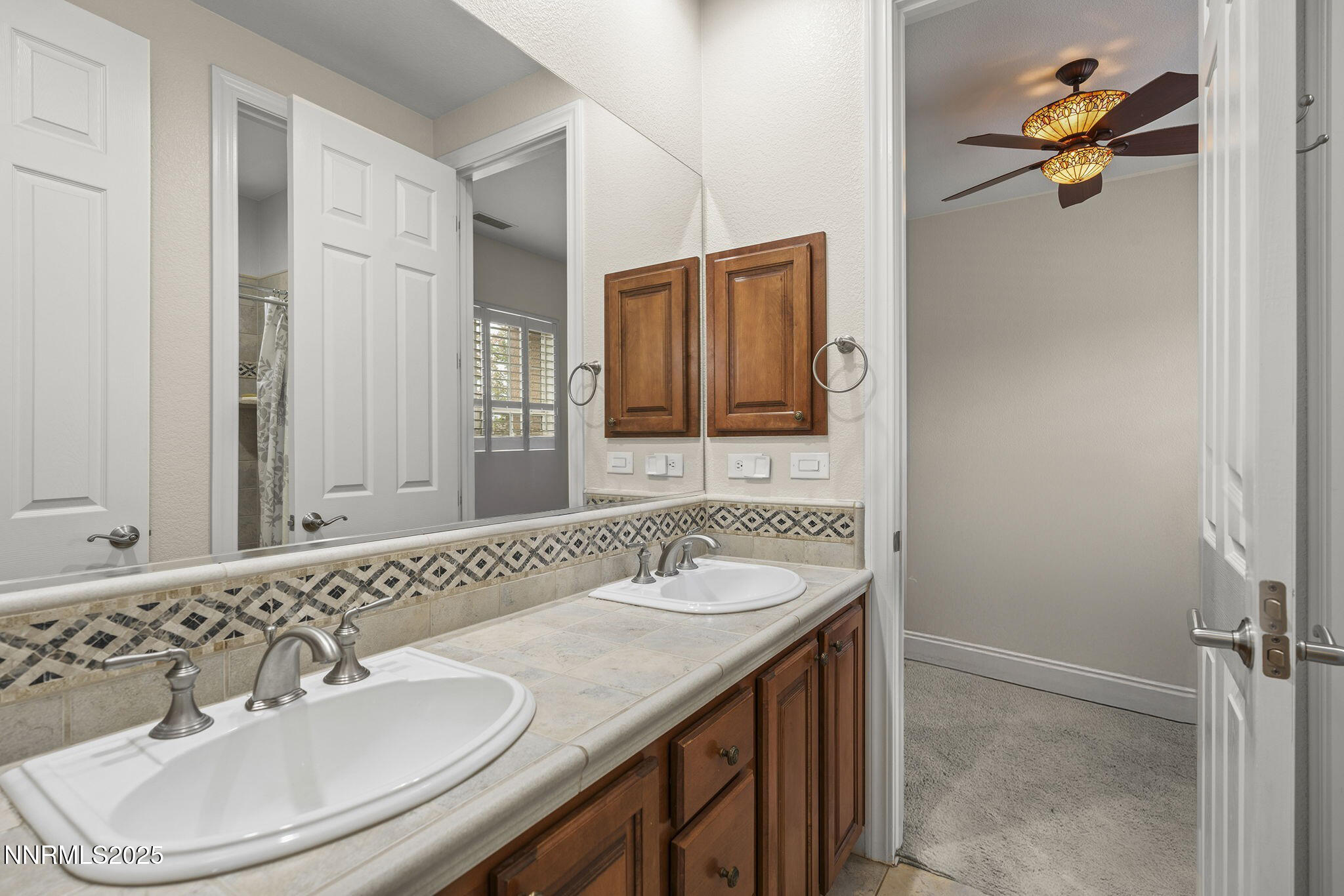 6225 Elk Ivory Drive Reno, NV 89511 - Photo 22 of 44 a bathroom with a sink and a mirror