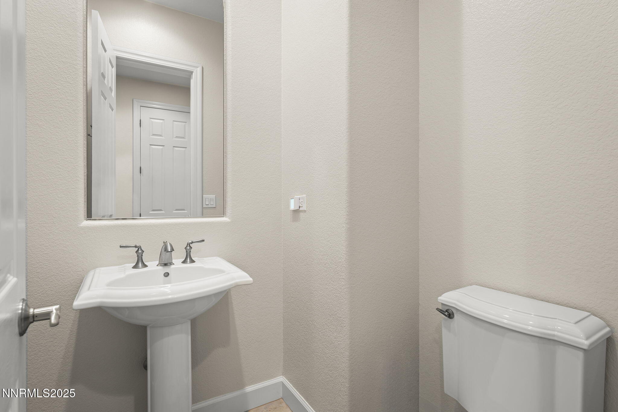 6225 Elk Ivory Drive Reno, NV 89511 - Photo 24 of 44 a bathroom with a sink a toilet and mirror