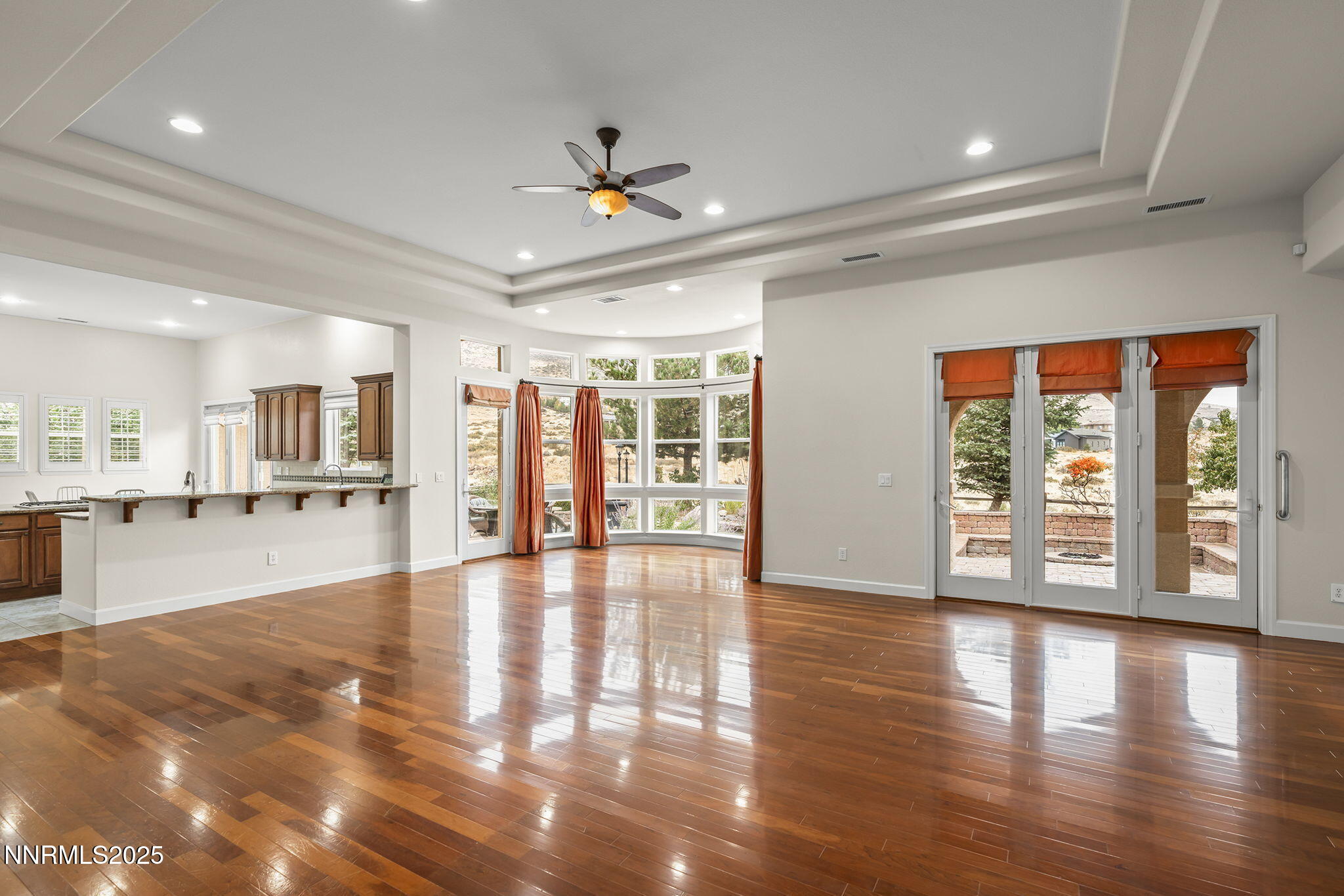 6225 Elk Ivory Drive Reno, NV 89511 - Photo 3 of 44 a view of an empty room with wooden floor and a window