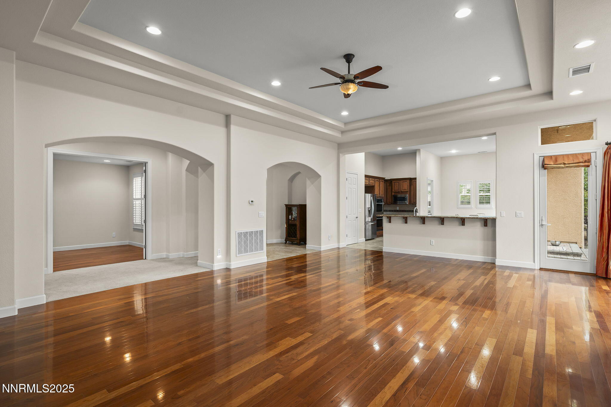 6225 Elk Ivory Drive Reno, NV 89511 - Photo 4 of 44 a view of an empty room with window and wooden floor