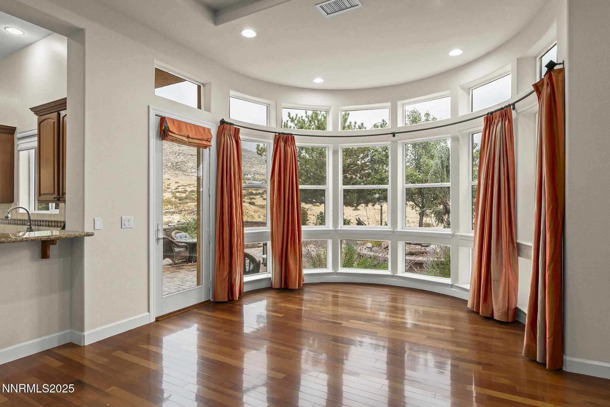6225 Elk Ivory Drive Reno, NV 89511 - Photo 7 of 44 a view of an empty room with window and wooden floor