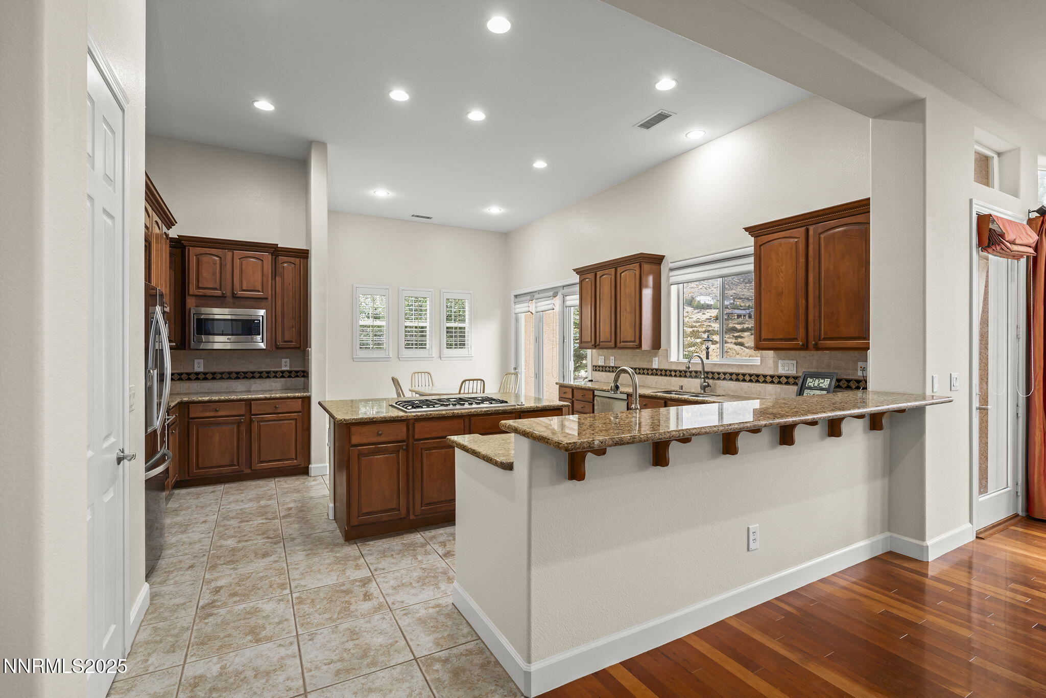 6225 Elk Ivory Drive Reno, NV 89511 - Photo 9 of 44 a kitchen with stainless steel appliances granite countertop a sink and cabinets