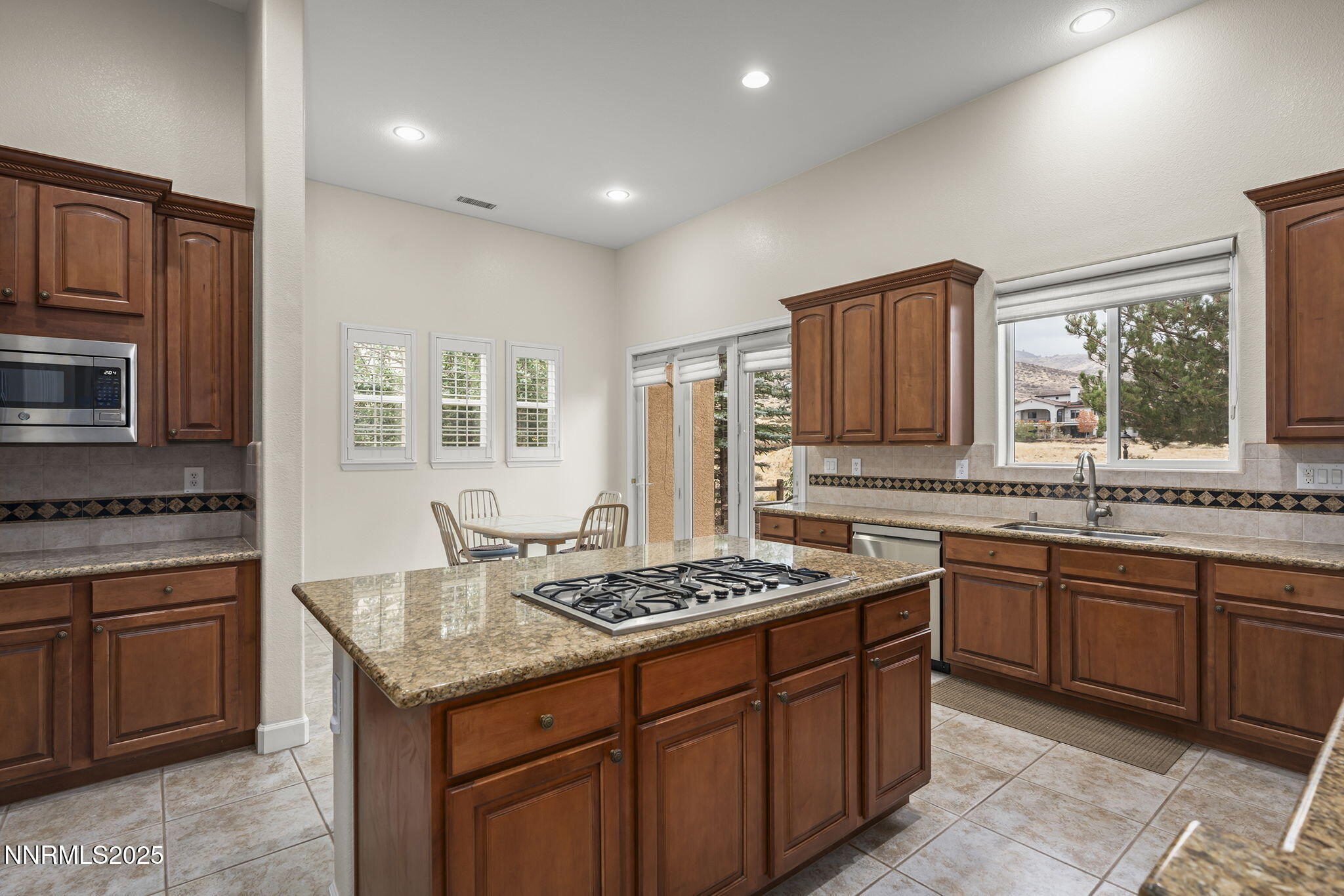 6225 Elk Ivory Drive Reno, NV 89511 - Photo 10 of 44 a kitchen with stainless steel appliances granite countertop a stove a sink dishwasher and a refrigerator