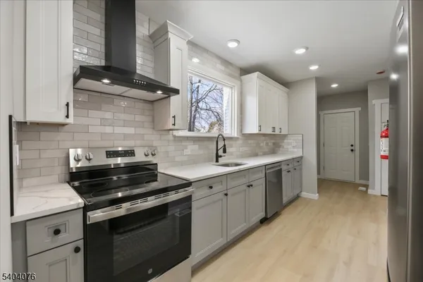 a kitchen with a sink stove and cabinets