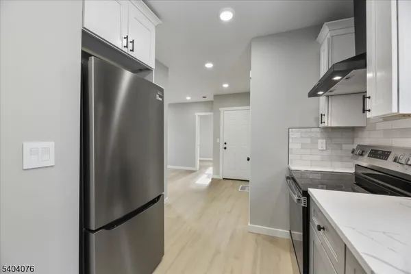 a kitchen with cabinets and window