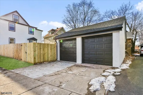 a view of a house with wooden fence
