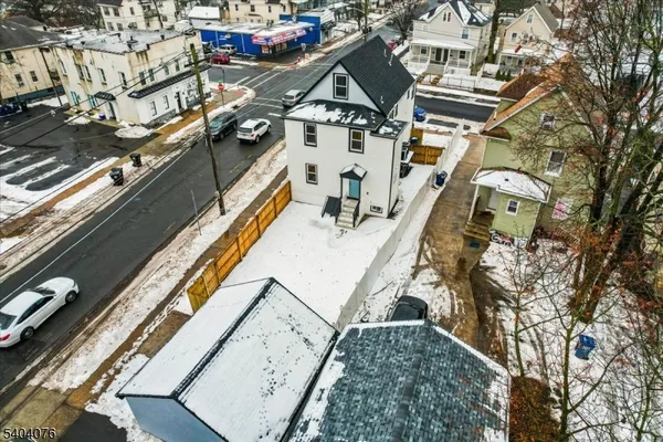 an aerial view of residential building and car parked