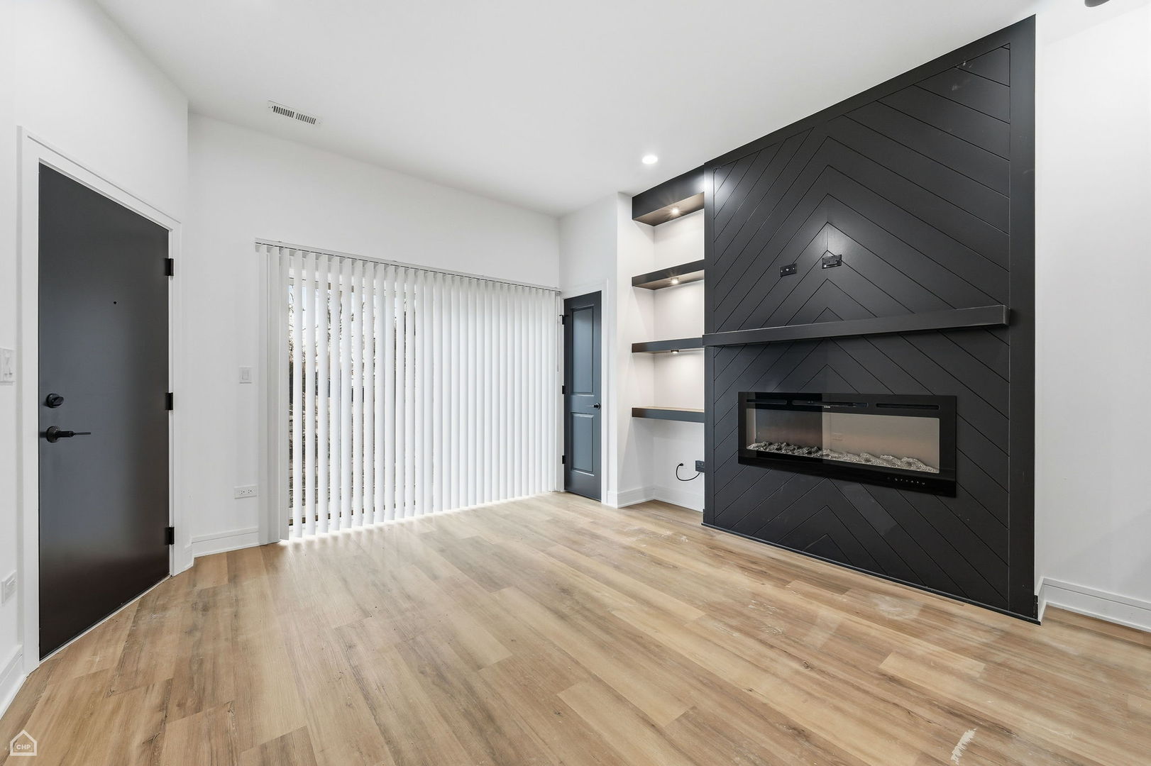 861 East 63rd Place, Unit 1 Chicago, IL 60637 - Photo 2 of 17 a view of a livingroom with wooden floor and kitchen space