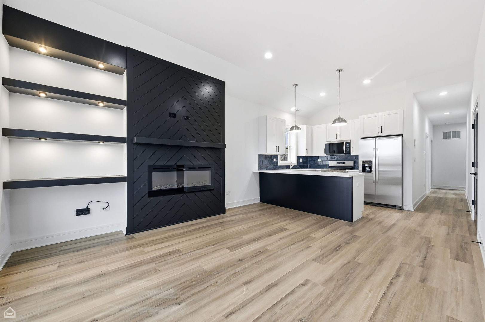 861 East 63rd Place, Unit 1 Chicago, IL 60637 - Photo 3 of 17 a kitchen with stainless steel appliances kitchen island granite countertop a refrigerator oven a sink and dishwasher with wooden floor