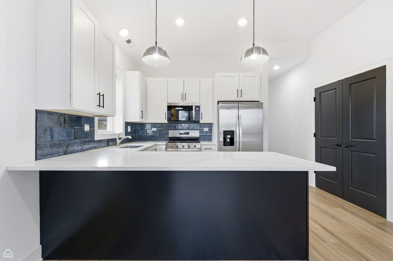 861 East 63rd Place, Unit 1 Chicago, IL 60637 - Photo 4 of 17 a kitchen with kitchen island a sink stainless steel appliances and cabinets