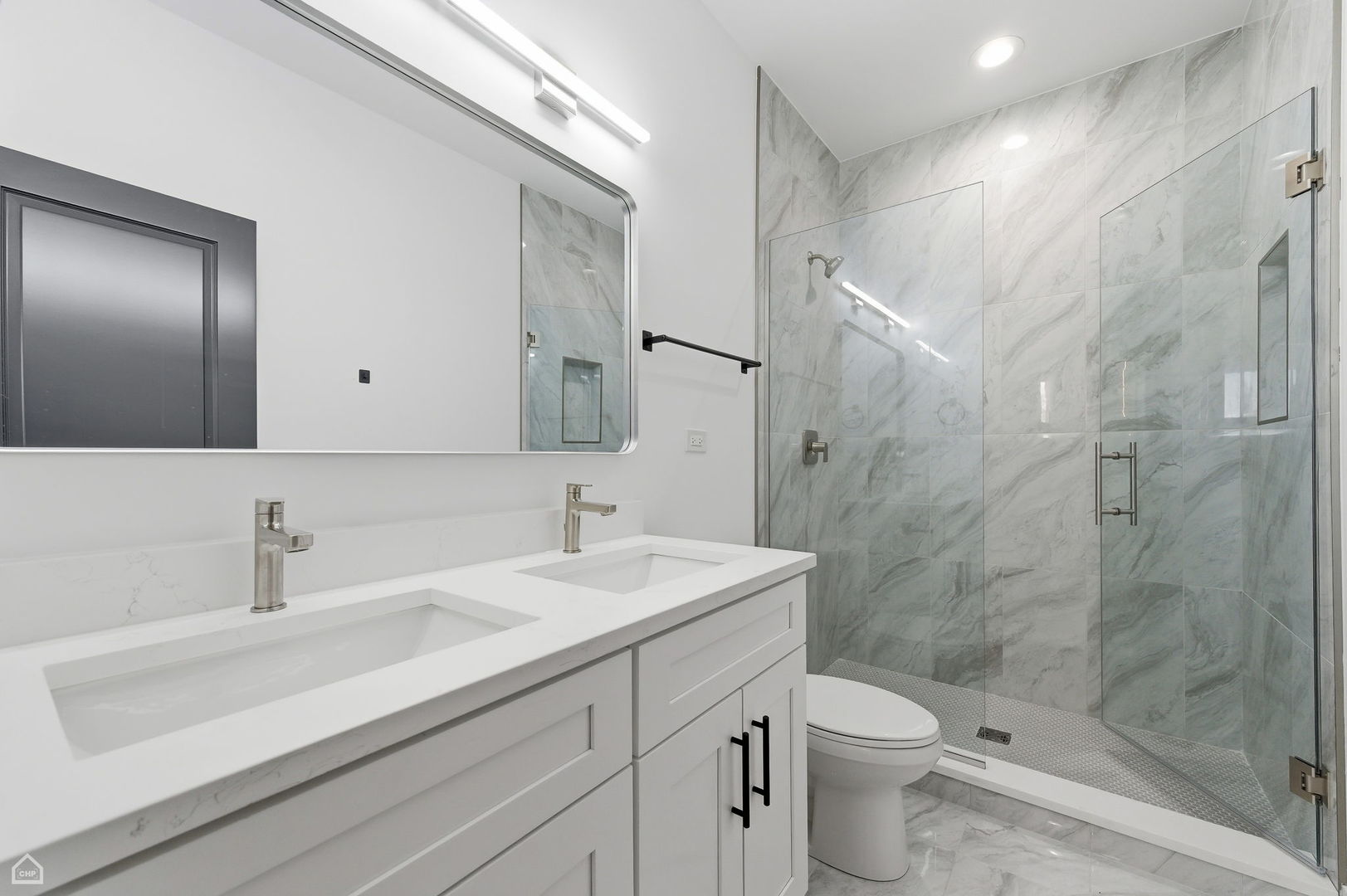 861 East 63rd Place, Unit 1 Chicago, IL 60637 - Photo 9 of 17 a bathroom with a sink a toilet and shower