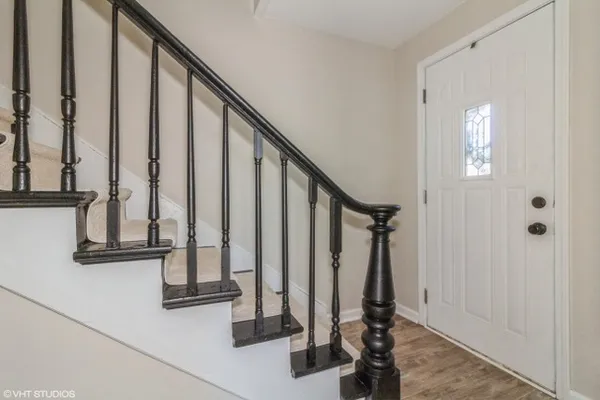 a view of staircase with wooden floor and windows