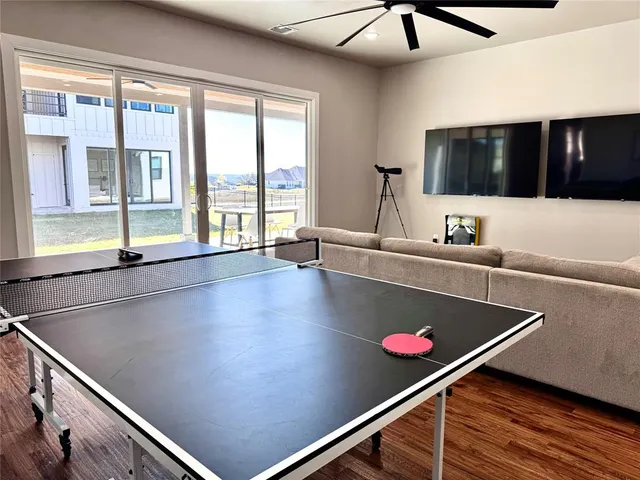 a room with pool table and windows