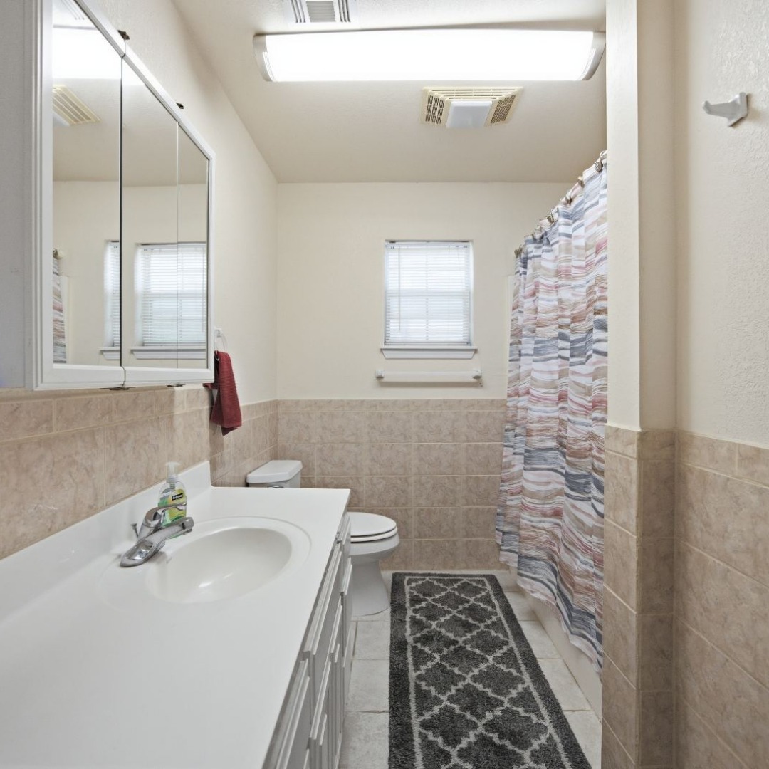 2696 Russellville Road Quinton, OK 74561 - Photo 12 of 40 Bathroom featuring a single vanity with an integrated sink, white cabinetry, and a mirrored medicine cabinet